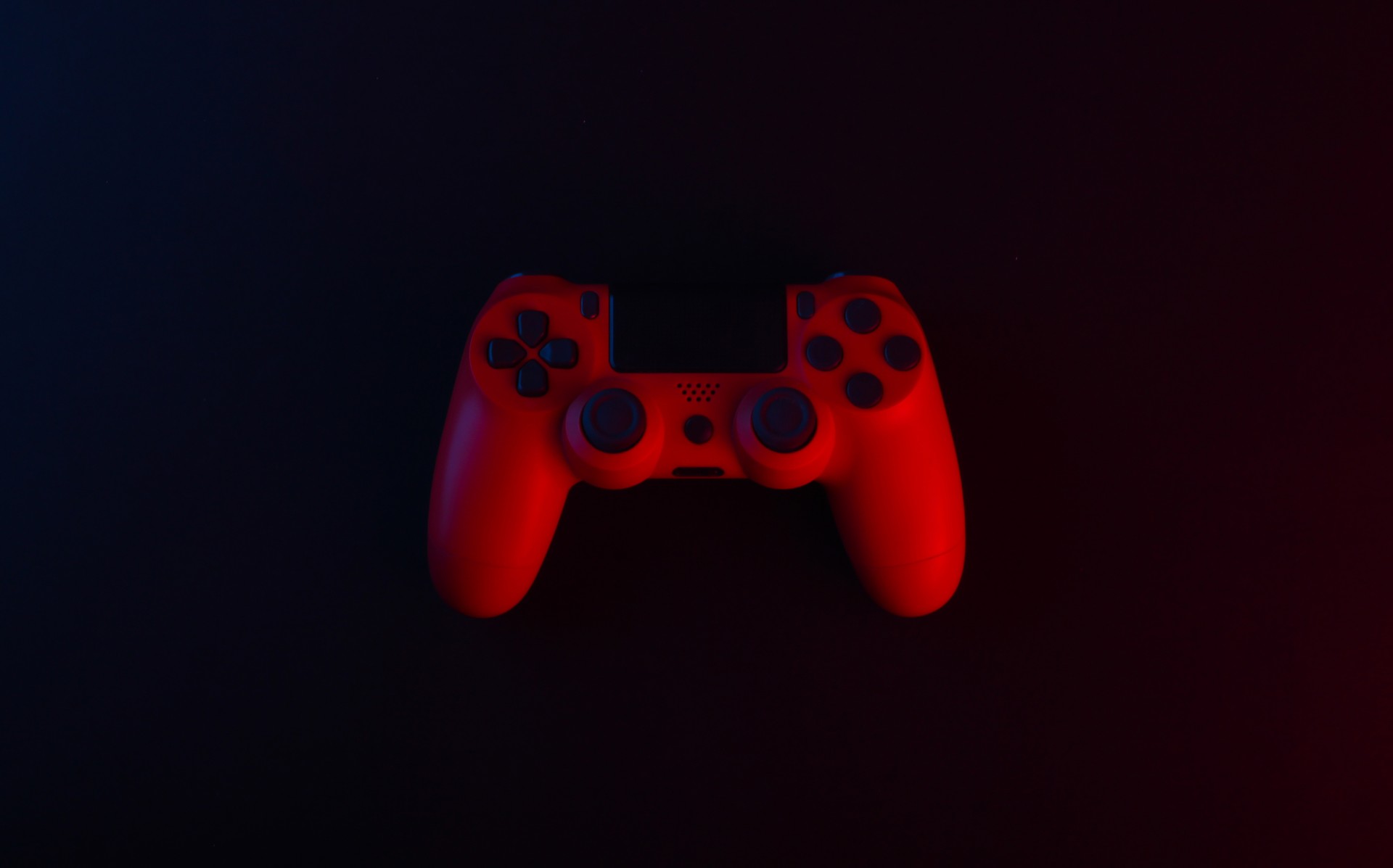 Red Gamepad on black backround. Gaming concept.