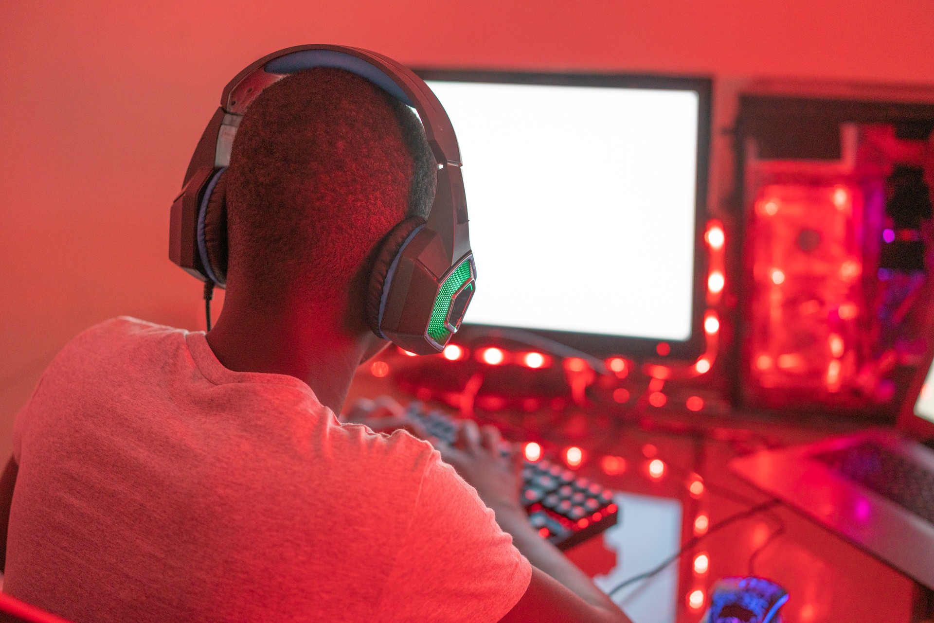 Young black male gamer playing at station